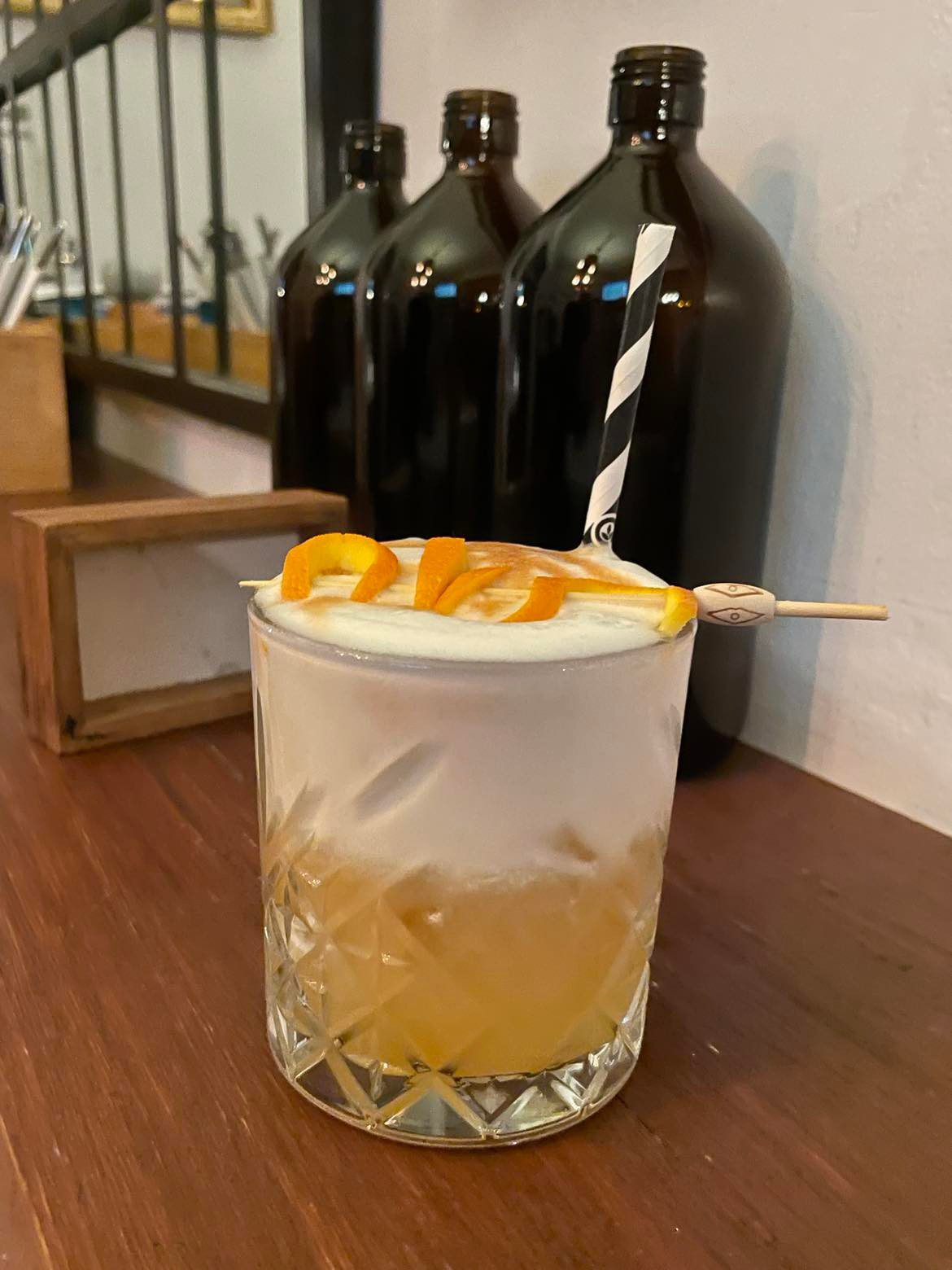 An Amaretto Sour on a bar top.