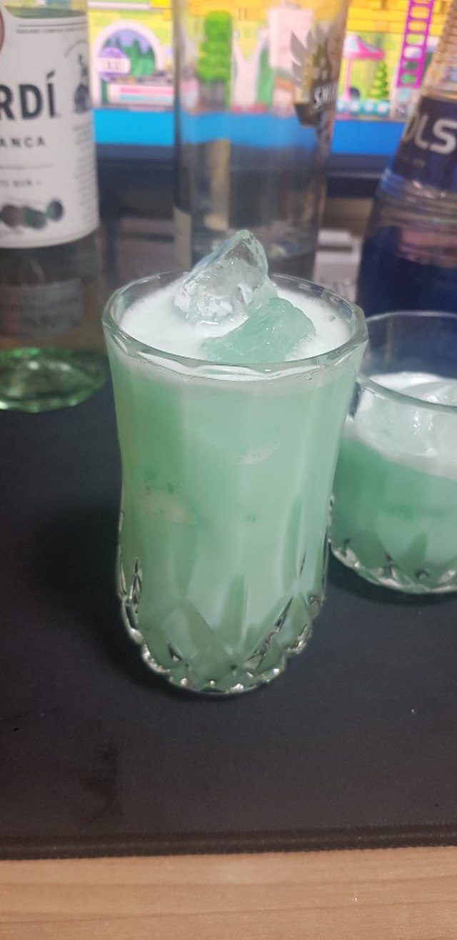 A Blue Hawaiian cocktail on a bar.