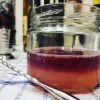 A close up photo of a Oaxaca Sour with a mixing spoon in the foreground.