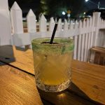 A Paloma cocktail on an outdoor restaurant table.