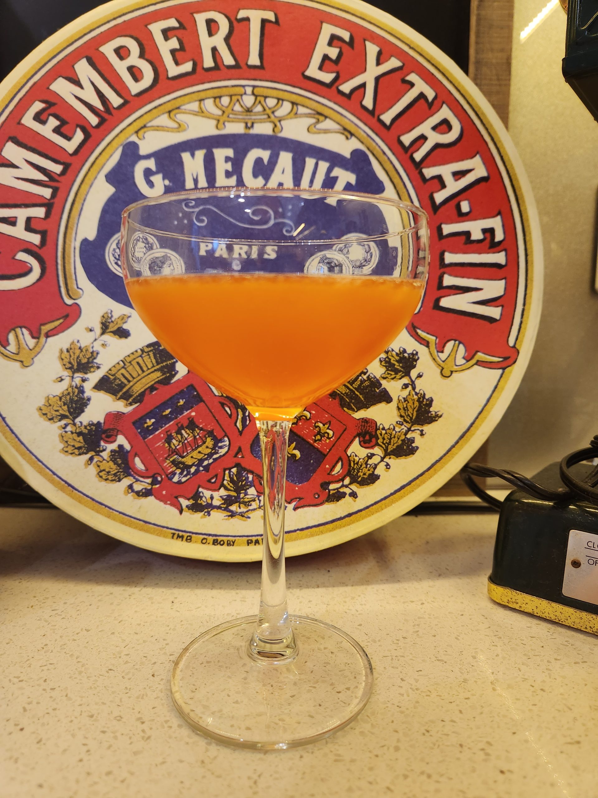 A Paperplane cocktail in a coupe glass.