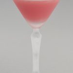 A Pink Lady cocktail in a stylised Martini glass.