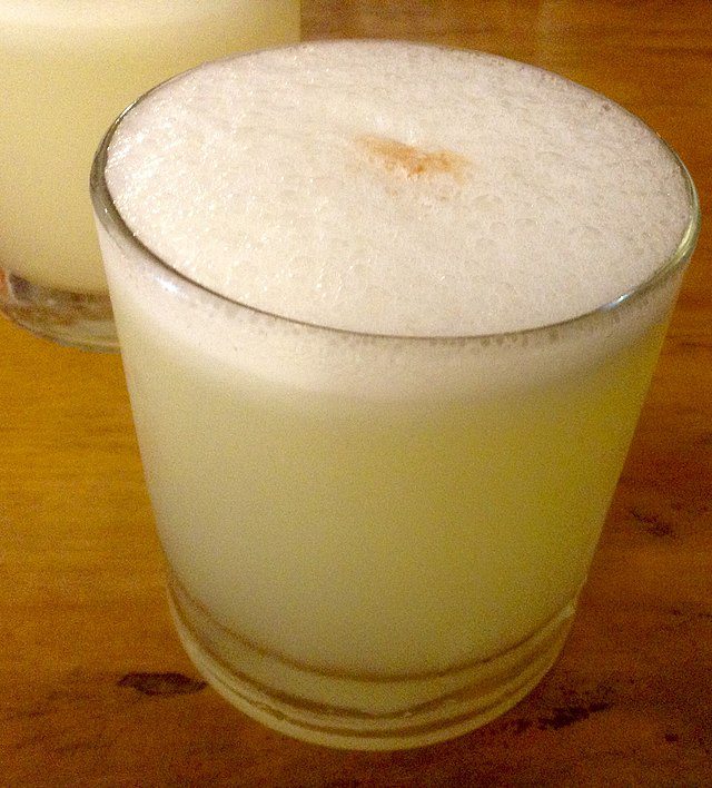 Pisco Sour on a wood table.
