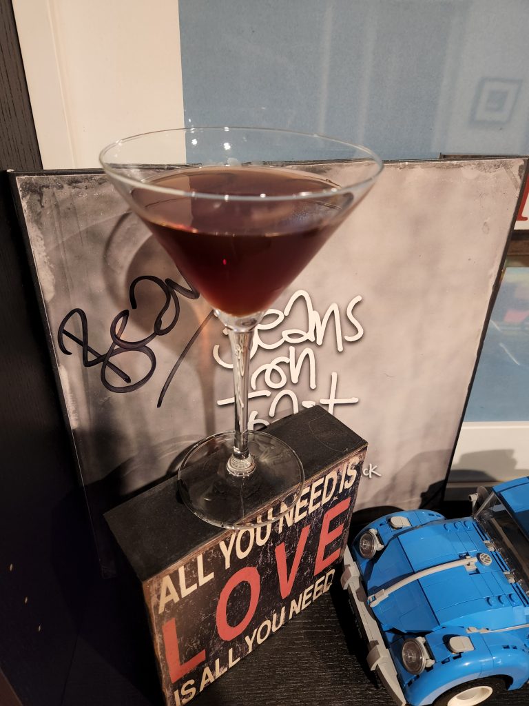 A Reverse Manhattan cocktail in front of a vinyl record.