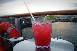 A Sea Breeze cocktail on a table on a boat.