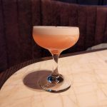 A Clover Club Cocktail on a bar table.