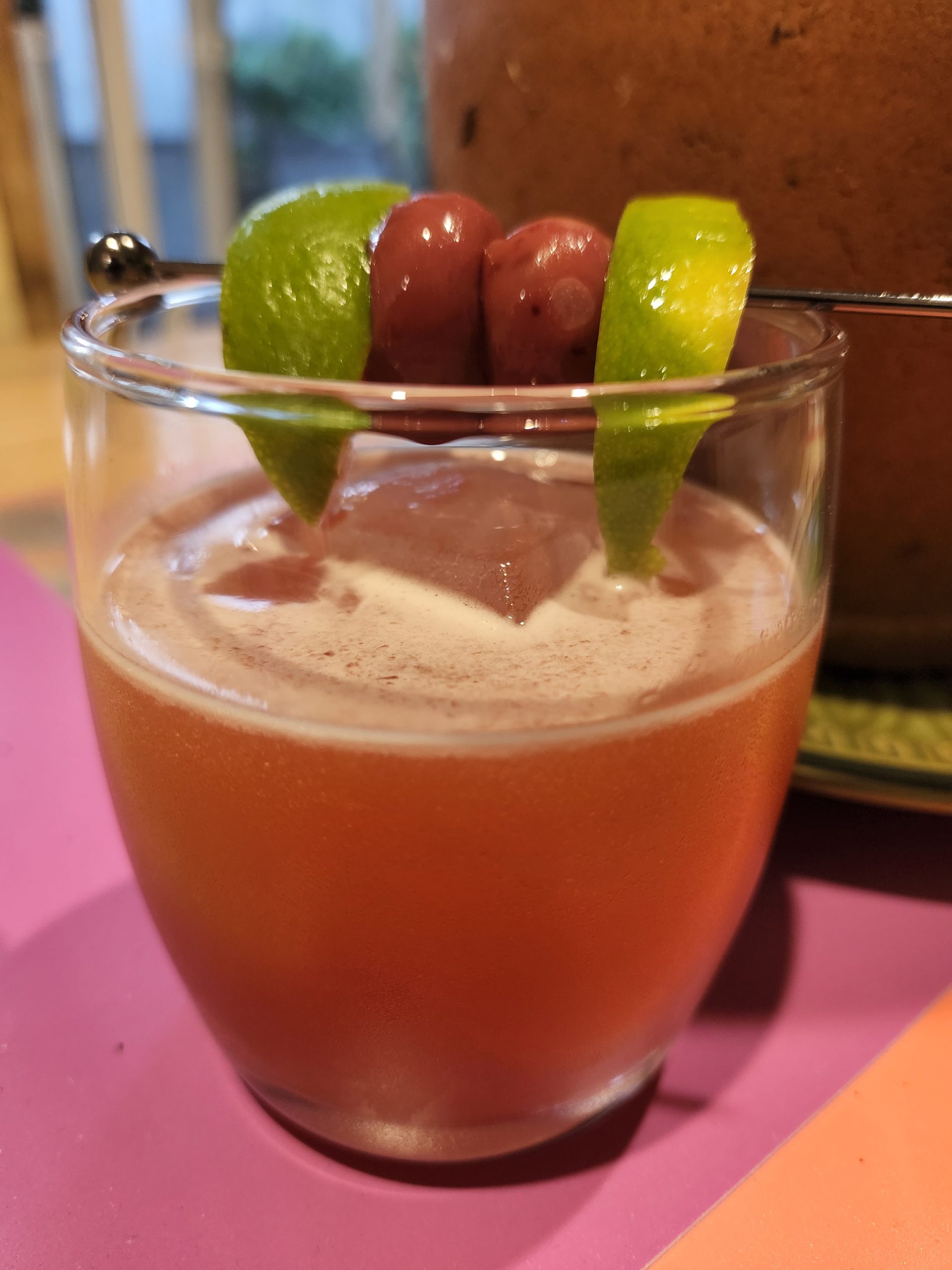 A Jungle Bird Cocktail on a table with garnish.