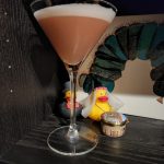 A Million Dollar Cocktail in front of two miniature rubber ducks.