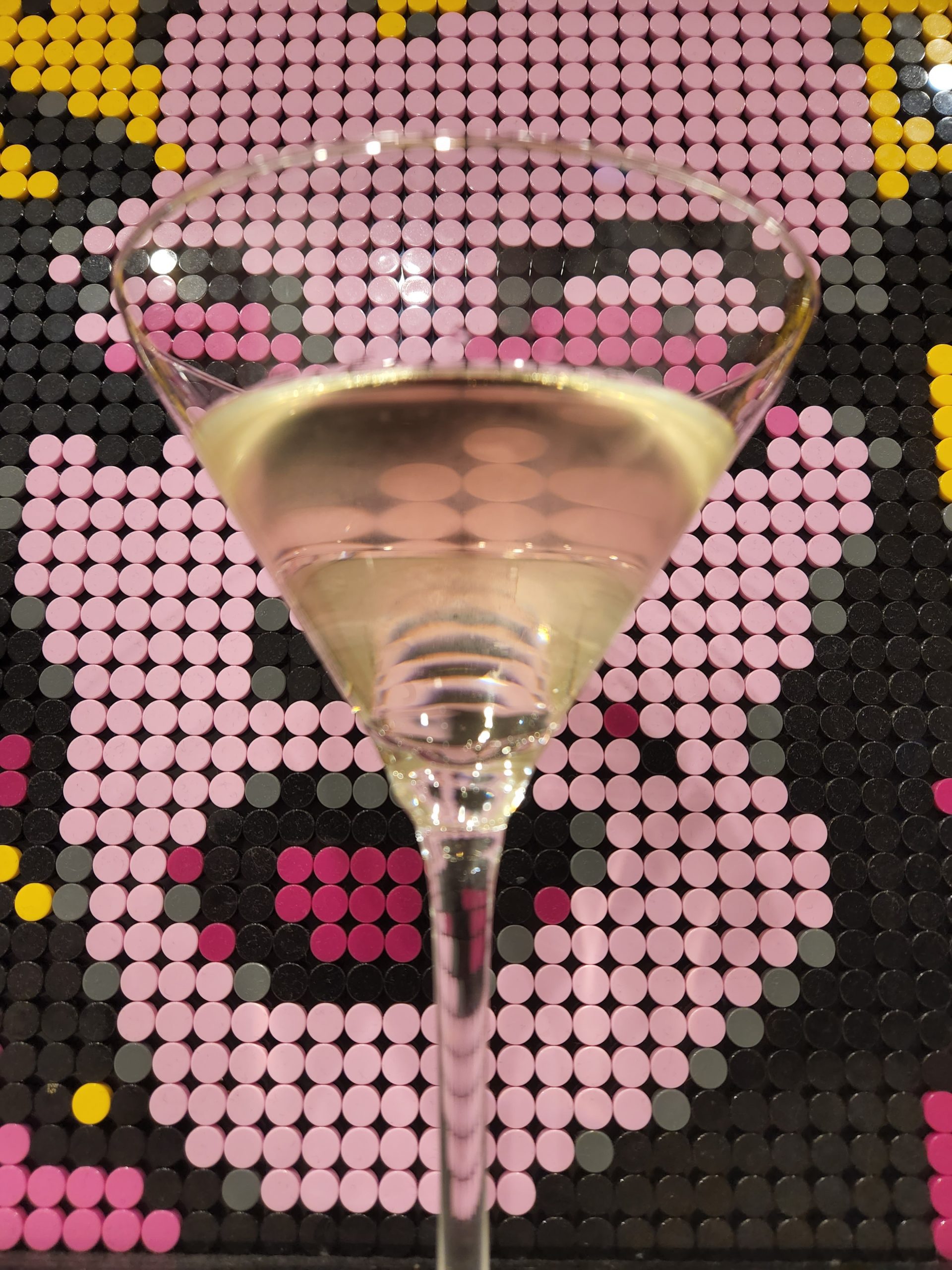 A Reverse Martini in front of a pop art style portrait of Marilyn Monroe.