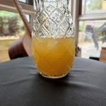 A Scorpion Bowl cocktail served in a glass that looks like a pineapple.