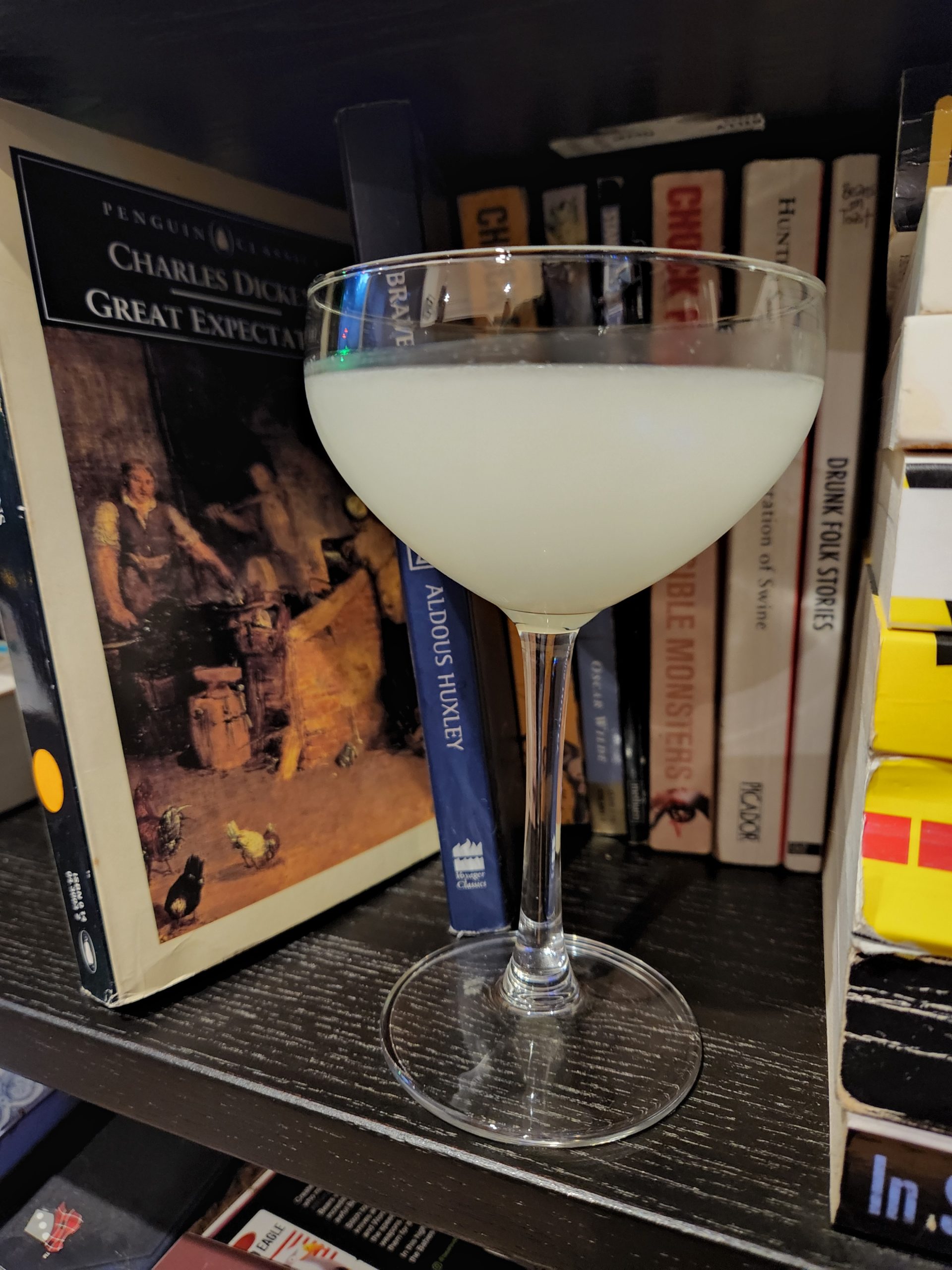 A Corpse Reviver cocktail on a book shelf.