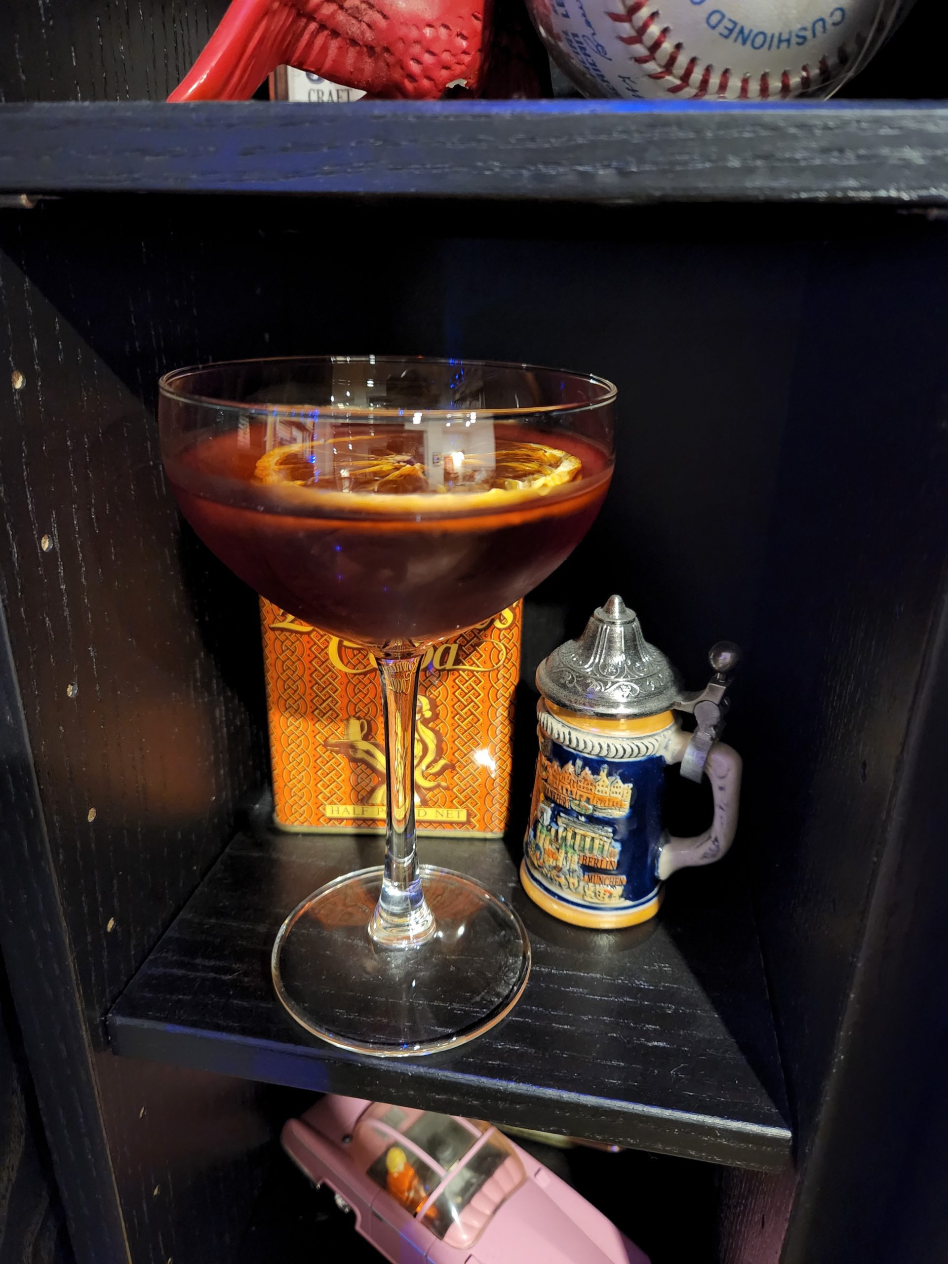 A Martinez cocktail sitting in front of a mini German beer stein.