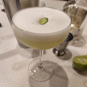 An El Pepino cocktail in a coupe glass.