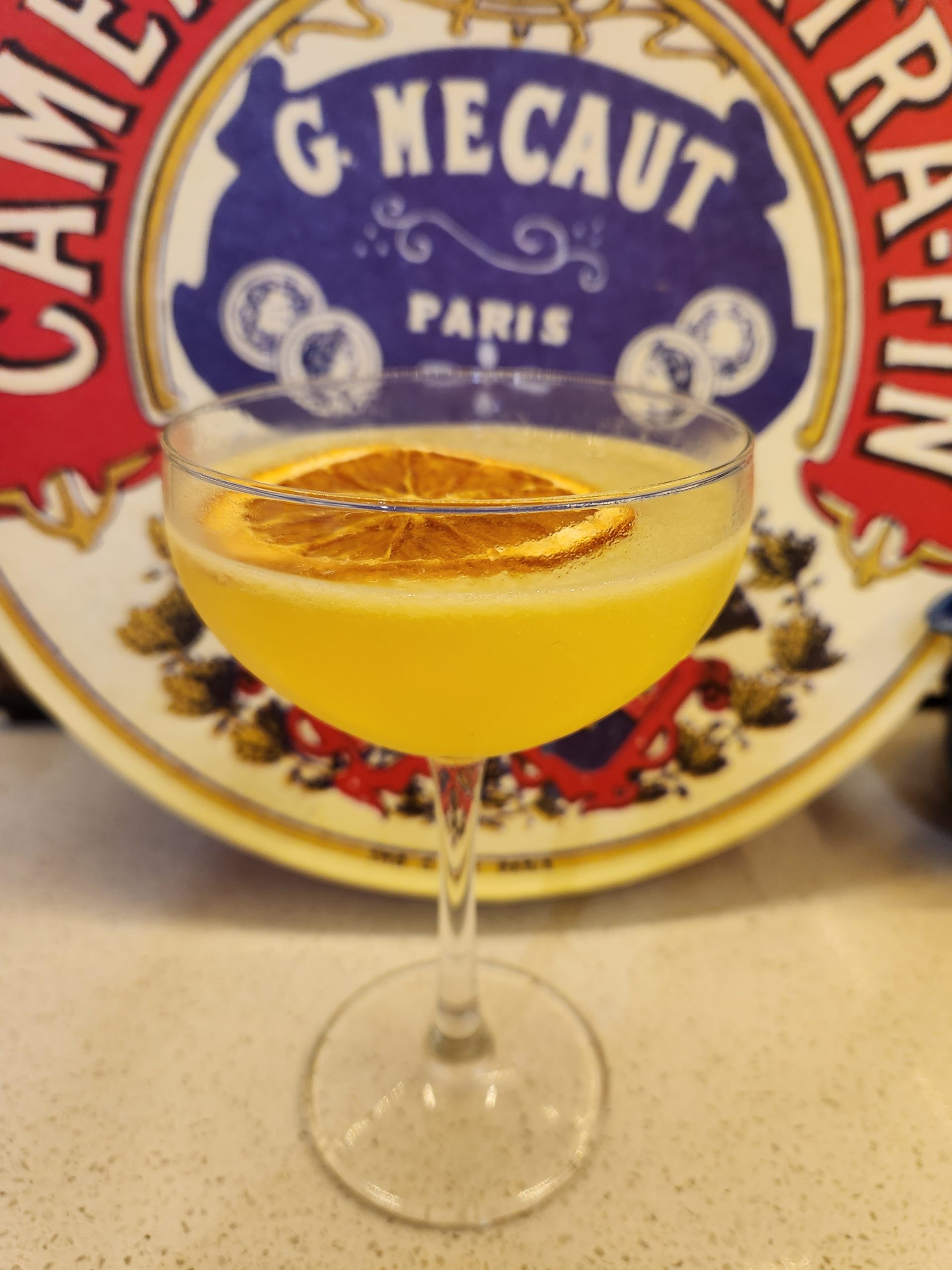 A Bees Knees cocktail in a coupe glass.