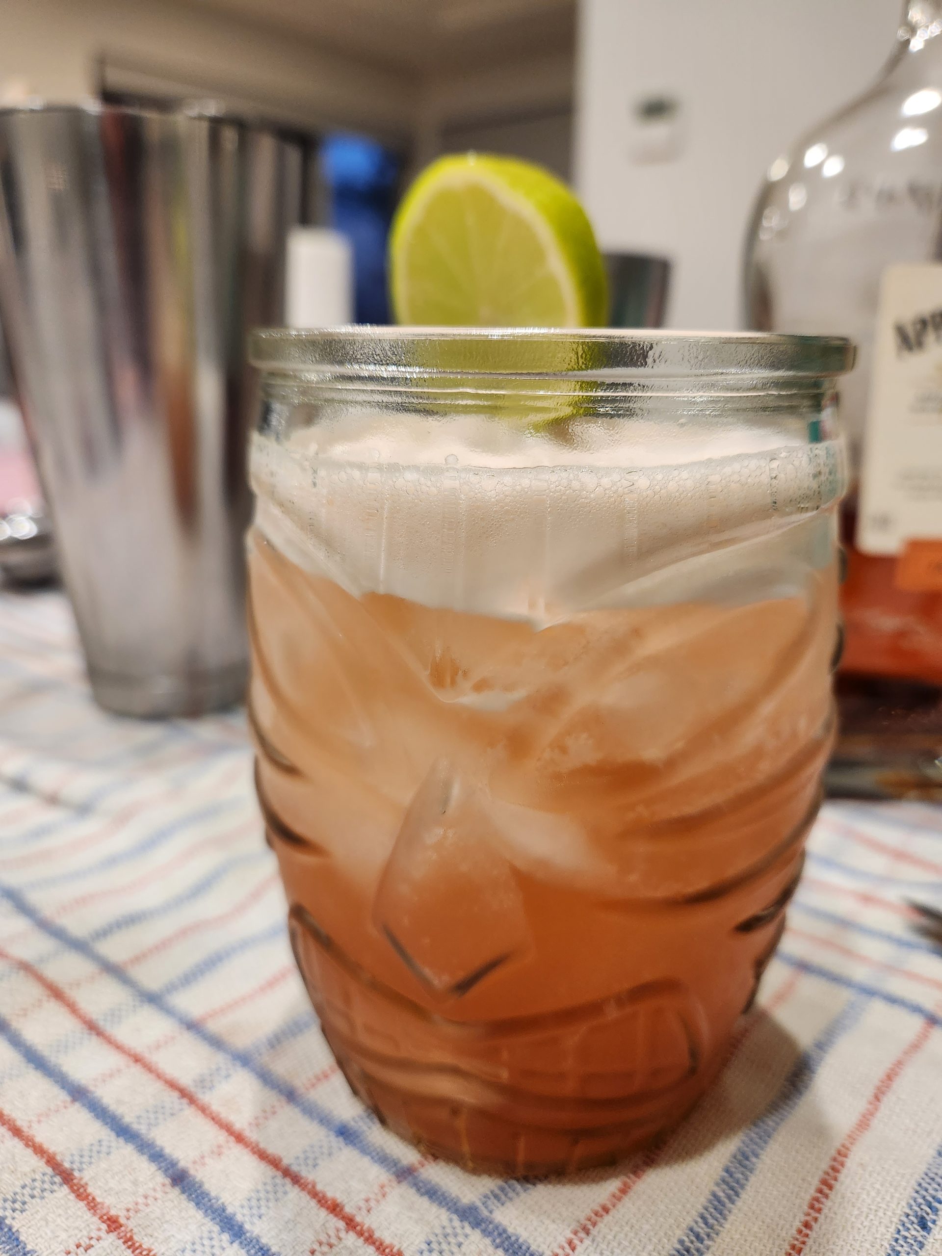 A Planters Punch cocktail in a glass Tiki mug.