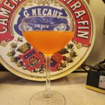 A Paperplane cocktail in a coupe glass.