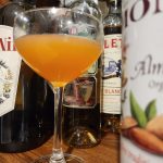 Naked and Famous cocktail on a shelf.